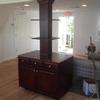 Service and waitress station in French restaurant built around support column in middle of dining room. 