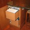 File cabinet built into end of island for household items and bills