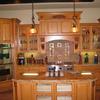 Kitchen in same home with display drawers in island, special hood cabinet and corbels