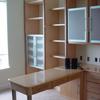 Home office in Maple and Cherry accents with aluminum framed milk glass doors